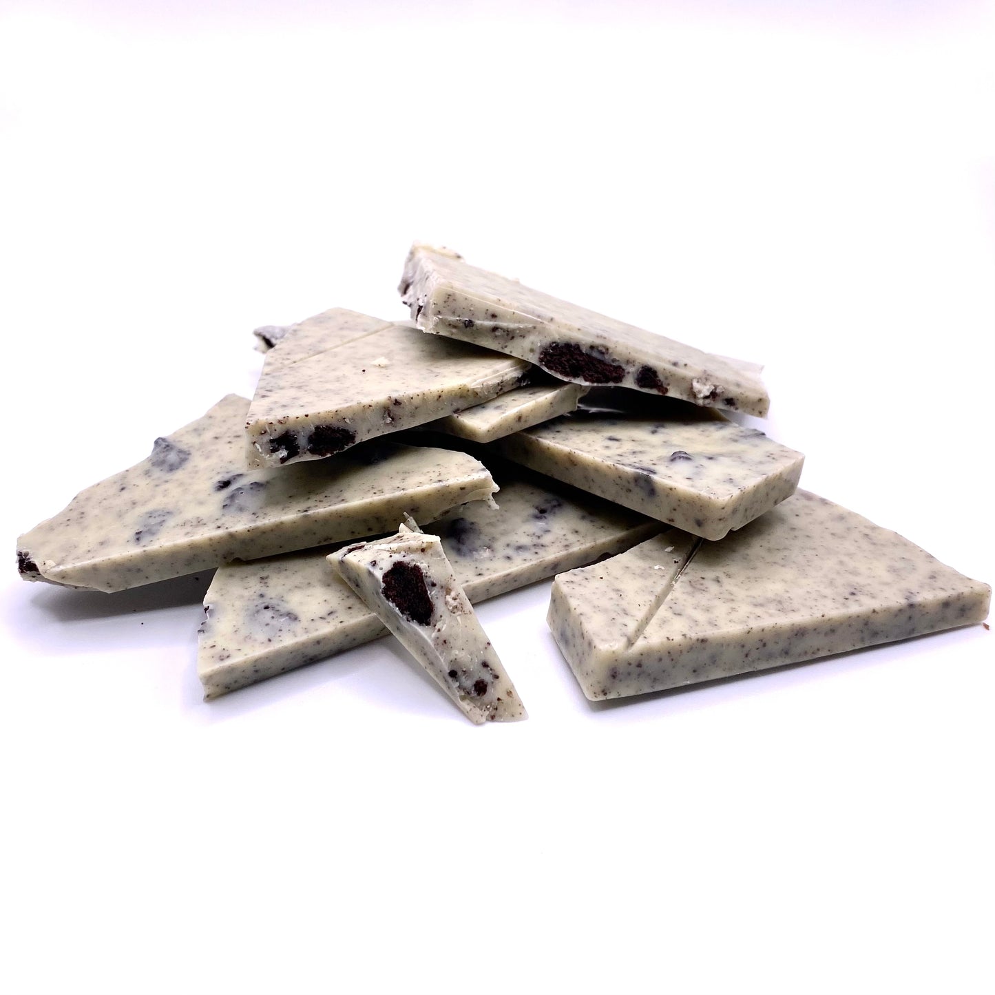 The Cookies and Cream bar broken up into pieces and piled on top of each other.