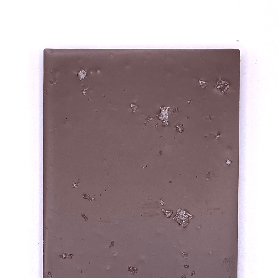 The back of the Dark Chocolate with Sea Salt bar, you can see the sea salt crystals in the bar.