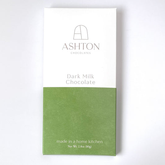 Dark Milk Chocolate Bar box on a white background. The box is white on top and green on the bottom.